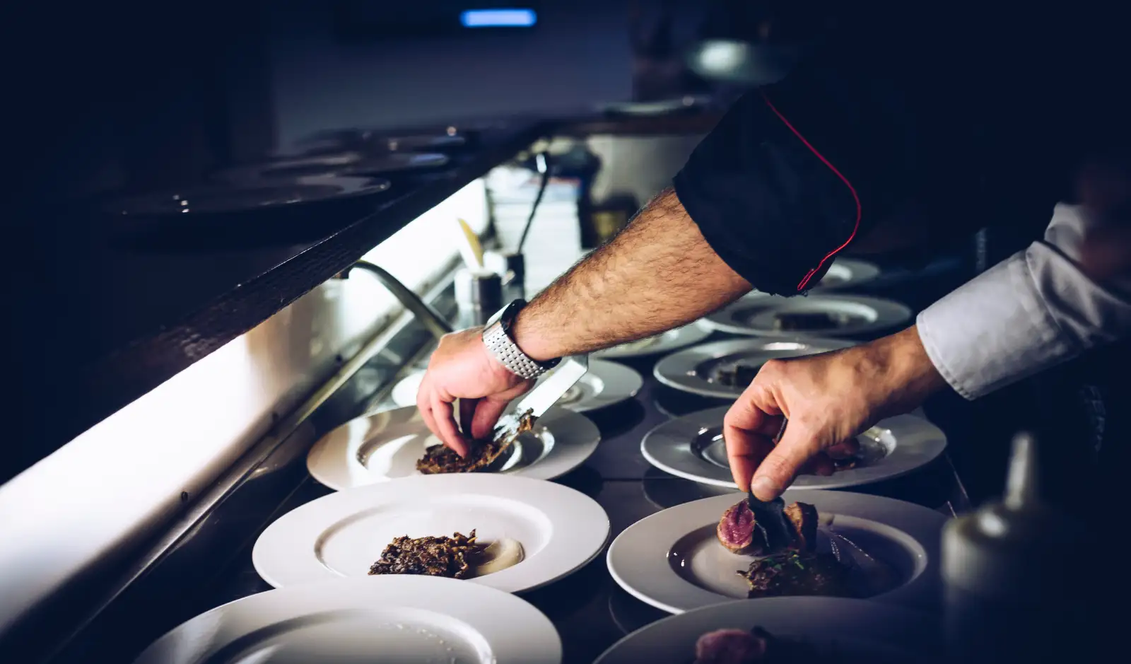 Plating the pasta at the pass